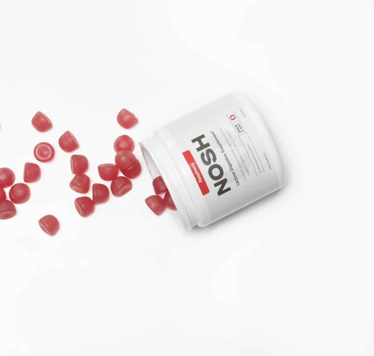NOSH raspberry gummies spilling out of a tipped tub